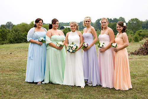 bride with bridesmaids in multi-colored dresses