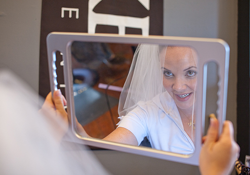 bride looking at reflection in mirror