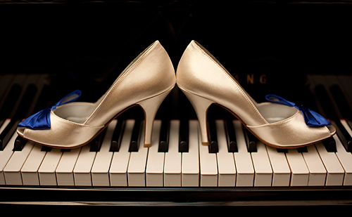wedding shoes with blue bows on piano