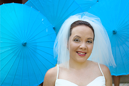bride in front of blue paper umbrellas