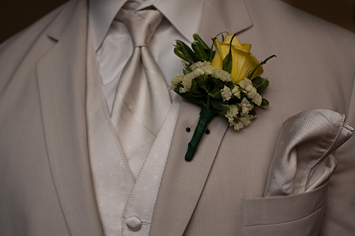 groom's tuxedo with yellow rose on lapel