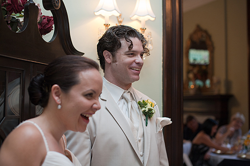 groom and bride laughing at speech