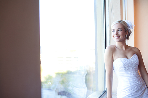 beautiful bride looking out window