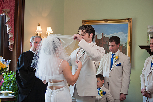 groom raising brides veil
